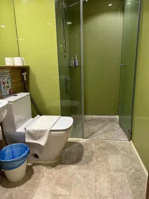 a bathroom with a toilet and a glass shower at Sky Suites KLCC Luxury Cozy Suites in Kuala Lumpur