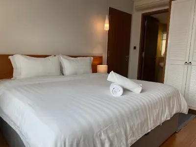 a large white bed with a white towel on it at Sky Suites KLCC Luxury Cozy Suites in Kuala Lumpur
