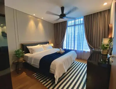 a bedroom with a bed with a ceiling fan at Sky Suites KLCC Luxury Cozy Suites in Kuala Lumpur