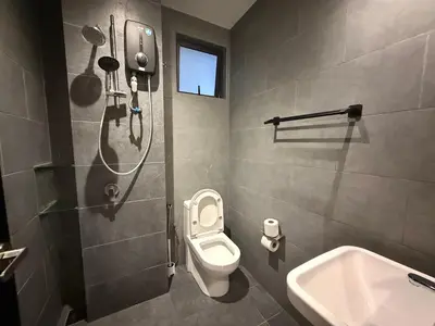 a bathroom with a shower and a toilet and a sink at Neu Suites Kuala Lumpur By Vglory Home in Kuala Lumpur