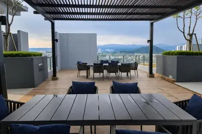 a table and chairs on the roof of a building at Neu Suites Kuala Lumpur By Vglory Home in Kuala Lumpur