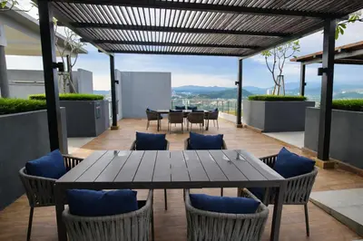 a table and chairs on the roof of a building at Neu Suites Kuala Lumpur By Vglory Home in Kuala Lumpur