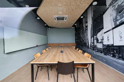 a conference room with a wooden table and chairs at Neu Suites Kuala Lumpur By Vglory Home in Kuala Lumpur