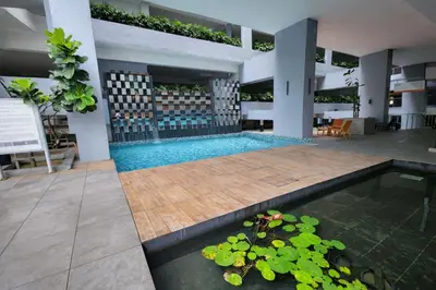 a swimming pool in a building with a plant at Neu Suites Kuala Lumpur By Vglory Home in Kuala Lumpur