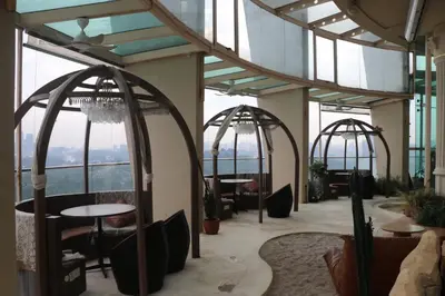 a restaurant with arches and tables in a building at Regalia SkyPool8 in Kuala Lumpur