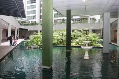a mall with a fountain in the middle of a building at Regalia SkyPool8 in Kuala Lumpur