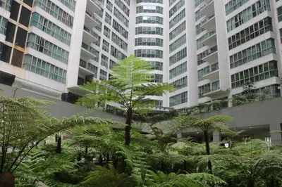 a garden in front of two tall buildings at Regalia SkyPool8 in Kuala Lumpur