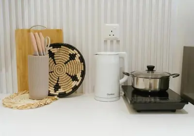 a counter top with a coffee maker and a blender at Cozy Cityscape Homestay in KL City Center 1-5pax in Kuala Lumpur