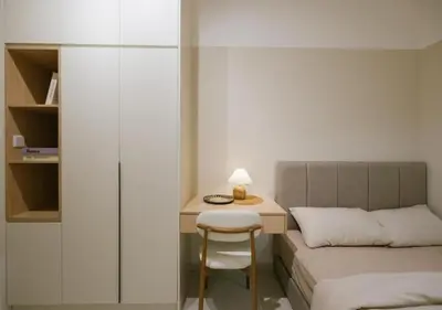 a small bedroom with a bed and a desk with a chair at Cozy Cityscape Homestay in KL City Center 1-5pax in Kuala Lumpur