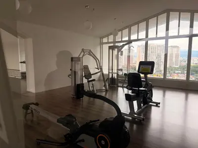 a gym with cardio equipment in a large room with windows at UNA Residence Maluri MRT Velocity TRX Bkt Bintang in Kuala Lumpur