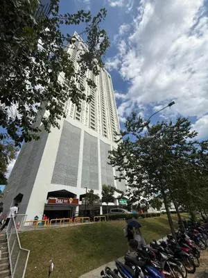 a large building with motorcycles parked in front of it at UNA Residence Maluri MRT Velocity TRX Bkt Bintang in Kuala Lumpur