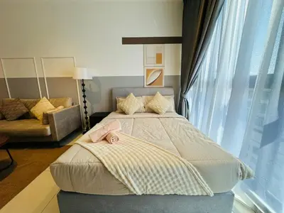 a bedroom with a large bed and a couch at Majestic Suites Klcc BY Mimi in Kuala Lumpur