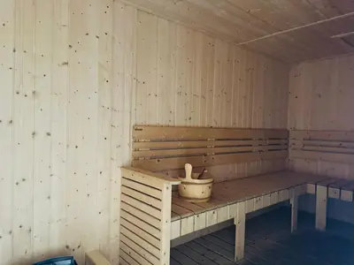 a wooden sauna with a bucket on a bench at Majestic Suites Klcc BY Mimi in Kuala Lumpur