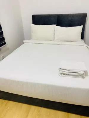 a white bed with white sheets and pillows on it at agile residence at gorgeous luxury in Kuala Lumpur