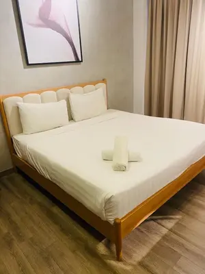 a bed with white sheets and a towel on it at agile residence at gorgeous luxury in Kuala Lumpur