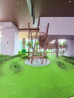 a playground in the middle of a building with green grass at Luxury Home At Axon Residence Bukit Bintang KLCC Pavilion in Kuala Lumpur
