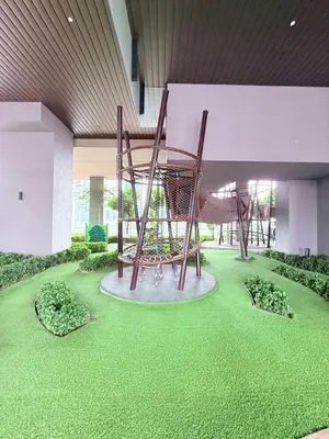 a playground in the middle of a building with green grass at Luxury Home At Axon Residence Bukit Bintang KLCC Pavilion in Kuala Lumpur