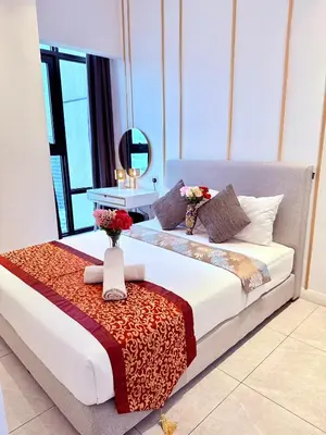 a hotel room with a bed with flowers on it at Luxury Home At Axon Residence Bukit Bintang KLCC Pavilion in Kuala Lumpur