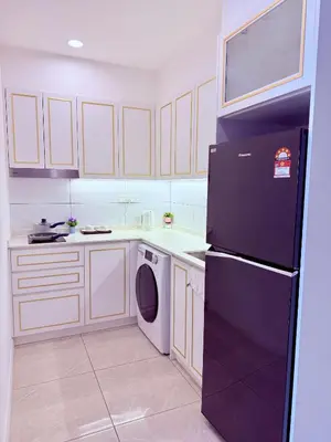 a kitchen with a black refrigerator and a dishwasher at Luxury Home At Axon Residence Bukit Bintang KLCC Pavilion in Kuala Lumpur