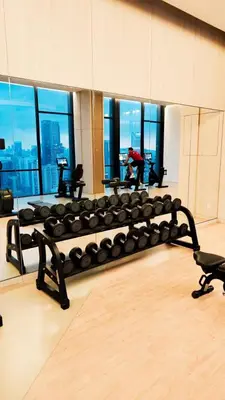 a bench in a gym with a view of a city at Axon in Kuala Lumpur