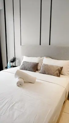 two beds with white sheets and pillows in a bedroom at Axon in Kuala Lumpur