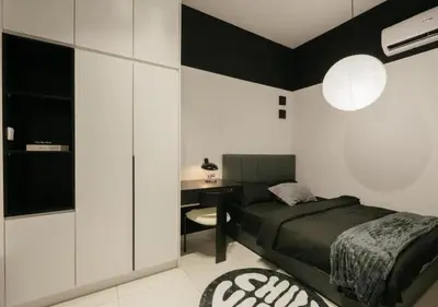 a bedroom with a bed and a desk at Cool Cityscape Homestay in KL City Center 1-5pax in Kuala Lumpur