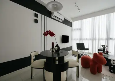 a living room with a table and chairs and a room with at Cool Cityscape Homestay in KL City Center 1-5pax in Kuala Lumpur