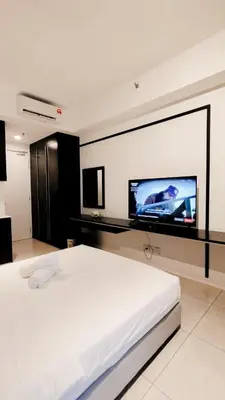 a bedroom with a large bed and a flat screen tv at Axon premier suites, Pavilion Bukit bingtang, KL Tower in Kuala Lumpur