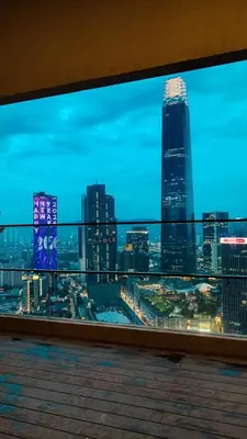 a view of a city skyline from a balcony at Axon premier suites, Pavilion Bukit bingtang, KL Tower in Kuala Lumpur