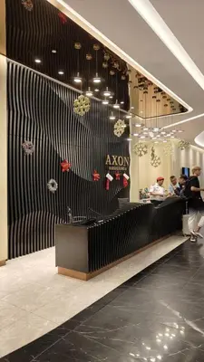 a store lobby with people standing around a counter at Axon premier suites, Pavilion Bukit bingtang, KL Tower in Kuala Lumpur