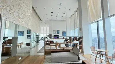 a living room with tables and chairs and windows at The Platinum KLCC By Pool Point in Kuala Lumpur