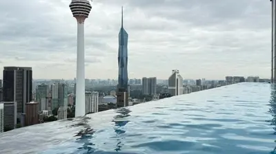 a infinity pool on the roof of a building with a city at The Platinum KLCC By Pool Point in Kuala Lumpur