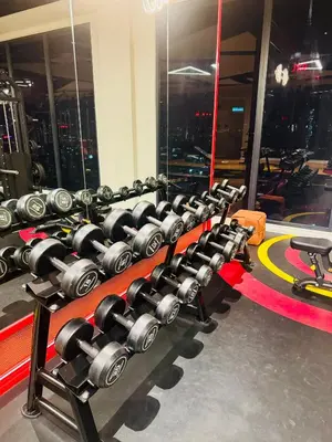 a row of dumbbells in a gym at Majestic Residence klcc by Stay Suites in Kuala Lumpur