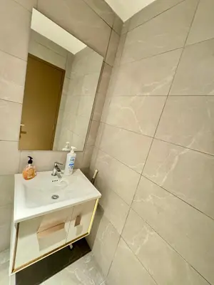 a bathroom with a sink and a mirror at Majestic Residence klcc by Stay Suites in Kuala Lumpur