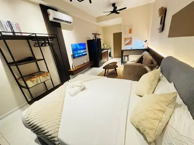 a living room with a white bed and a couch at Majestic Residence klcc by Stay Suites in Kuala Lumpur