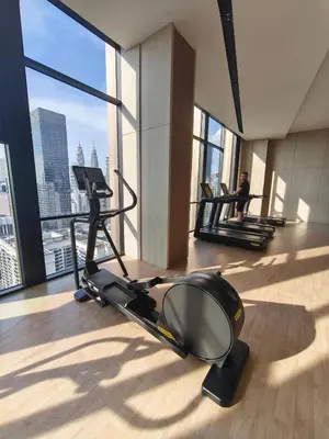 a gym with two people on treadmills in a building at AXON RESIDENCE by DREAM HOME in Gua Sai
