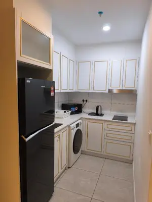a kitchen with a black refrigerator and a dishwasher at AXON RESIDENCE by DREAM HOME in Gua Sai