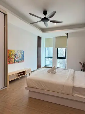 a bedroom with a bed and a ceiling fan at Casa Bukit Bintang By Eryan Guest House in Kuala Lumpur
