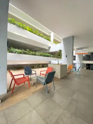 a group of chairs and tables in a building at Neu Suites KLCC by HMM Home in Kuala Lumpur