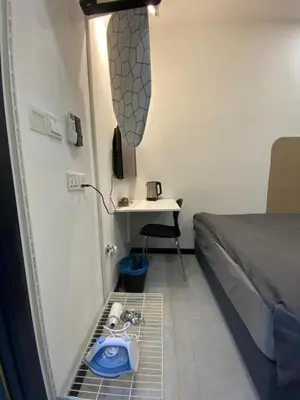 a small room with a bed and a sink in it at Neu Suites KLCC by HMM Home in Kuala Lumpur