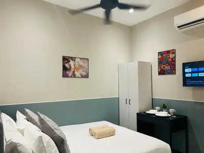 a bedroom with a bed and a ceiling fan at Neu Suites Apartment - Cozy Modern Stay near KLCC in Kuala Lumpur