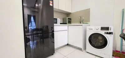 a kitchen with a refrigerator and a washing machine at Arte Mont Kiara By Whitedoorz in Kuala Lumpur