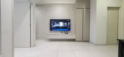 a living room with a tv on a white wall at Arte Mont Kiara By Whitedoorz in Kuala Lumpur