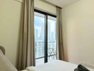 a bedroom with a window with a view of a city at The Manor Kuala Lampur in Kuala Lumpur