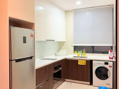 a kitchen with a white refrigerator and a dishwasher at The Manor Kuala Lampur in Kuala Lumpur