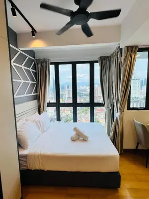 a bedroom with a bed with a ceiling fan at LUXE KLCC SKY LiNE in Kuala Lumpur