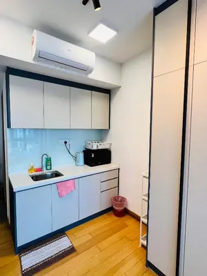 a kitchen with white cabinets and a sink at LUXE KLCC SKY LiNE in Kuala Lumpur