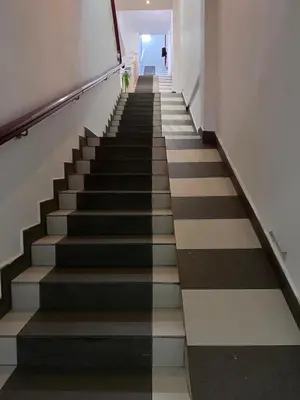 a long staircase with black and white floors at Ocean 77 by Pillow Plus Petaling Street KL in Kuala Lumpur