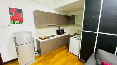 a small kitchen with a refrigerator and a microwave at Regalia SkyLux Studio in Kuala Lumpur