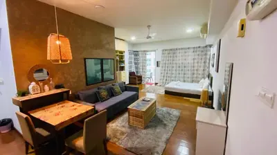 a living room with a couch and a table at Regalia SkyLux Studio in Kuala Lumpur